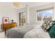 Bright bedroom with a light fixture and windows overlooking a scenic neighborhood at 1833 E Jewell Ave, Denver, CO 80210