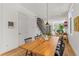 Dining room features a long wooden table and chairs under modern lighting fixtures at 1833 E Jewell Ave, Denver, CO 80210