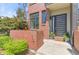 Charming front entrance with modern door and a brick facade, accented with potted plants and stylish address numbers at 1833 E Jewell Ave, Denver, CO 80210