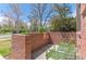 Quaint brick front porch with seating, perfect for enjoying the outdoors in a serene and welcoming atmosphere at 1833 E Jewell Ave, Denver, CO 80210