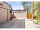 Two car detached garage with a spacious driveway and privacy fence at 1833 E Jewell Ave, Denver, CO 80210