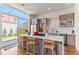 Modern kitchen with a large island, stainless appliances, and a view of the backyard at 1833 E Jewell Ave, Denver, CO 80210