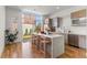 Modern kitchen with an island, stainless appliances, and bright natural light overlooking backyard at 1833 E Jewell Ave, Denver, CO 80210