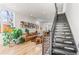 Open-concept living area featuring hardwood floors, modern staircase, and plenty of natural light at 1833 E Jewell Ave, Denver, CO 80210