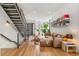 Bright living room with staircase and leather sectional, complemented by hardwood floors and modern decor at 1833 E Jewell Ave, Denver, CO 80210