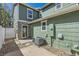 Backyard with newer exterior paint, new back door, and modern landscaping at 17244 E Kansas Dr, Aurora, CO 80017
