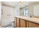 Bathroom featuring a double vanity, new fixtures, and a shower-tub combo at 17244 E Kansas Dr, Aurora, CO 80017