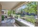 Inviting covered patio with decorative string lights offers a tranquil view of the neighborhood's landscaped grounds at 17244 E Kansas Dr, Aurora, CO 80017