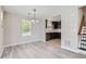 Bright dining area with modern flooring and stylish chandelier offers a seamless transition to the adjacent kitchen at 17244 E Kansas Dr, Aurora, CO 80017