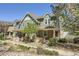 Inviting exterior showcasing a well-maintained, two-story home with charming stone accents and a lush, landscaped yard at 17244 E Kansas Dr, Aurora, CO 80017