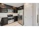 Well-equipped kitchen features stainless steel appliances and modern dark cabinetry, providing a sleek culinary space at 17244 E Kansas Dr, Aurora, CO 80017