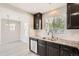 Modern kitchen features granite counters, dark cabinets and stainless appliances, with an eat-in space at 17244 E Kansas Dr, Aurora, CO 80017