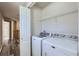 Convenient laundry room with side by side washer and dryer hookups and storage at 17244 E Kansas Dr, Aurora, CO 80017