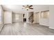Bright open-concept living room showcases modern floors, neutral walls, and flows into the dining and kitchen areas at 17244 E Kansas Dr, Aurora, CO 80017