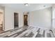 Spacious main bedroom featuring modern floors, walk-in closet, and ensuite bathroom at 17244 E Kansas Dr, Aurora, CO 80017