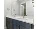 Modern bathroom featuring double sinks, gray cabinetry and modern fixtures at 5698 Farrier Pt, Castle Rock, CO 80104