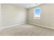A carpeted bedroom featuring a window overlooking the neighborhood at 5698 Farrier Pt, Castle Rock, CO 80104