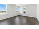 A bright, empty bedroom featuring large windows, neutral paint and trim and modern flooring at 5698 Farrier Pt, Castle Rock, CO 80104