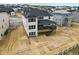 The home features a rear deck, with gray siding and black trimmed windows in a new neighborhood at 5698 Farrier Pt, Castle Rock, CO 80104