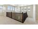 Upper hallway showing railing and views to the outside from a bank of windows at 5698 Farrier Pt, Castle Rock, CO 80104