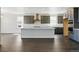 A modern kitchen boasts gray cabinets, stainless steel appliances, and a spacious island with quartz countertops at 5698 Farrier Pt, Castle Rock, CO 80104