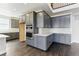 Modern kitchen features sleek gray cabinetry, stainless steel appliances, and elegant white backsplash tiles at 5698 Farrier Pt, Castle Rock, CO 80104