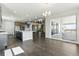 Expansive open-concept living area boasts a modern kitchen, dining space, and access to an outdoor deck at 5698 Farrier Pt, Castle Rock, CO 80104