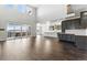 Bright, open-concept living space boasts soaring ceilings, hardwood floors, and seamless access to the kitchen and deck at 5698 Farrier Pt, Castle Rock, CO 80104