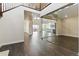 Open-concept living area with hardwood floors, modern lighting, glass-enclosed office and seamless flow to kitchen at 5698 Farrier Pt, Castle Rock, CO 80104