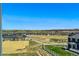 Expansive view of the surrounding neighborhood and rolling hills from a high vantage point of the property at 5698 Farrier Pt, Castle Rock, CO 80104