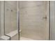 Modern walk-in shower featuring sleek tile work and a built-in bench at 11568 Dewey St, Parker, CO 80138