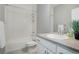 Bathroom featuring a shower-tub combo and a sleek vanity with a white vessel sink at 11568 Dewey St, Parker, CO 80138