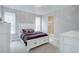 Comfortable bedroom featuring a plush bed, natural light, and ensuite bathroom access at 11568 Dewey St, Parker, CO 80138