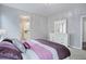 Inviting bedroom with an ensuite bathroom, dresser, and soft, neutral tones at 11568 Dewey St, Parker, CO 80138