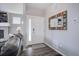Stylish entryway featuring a white door, decorative mirror, and wood-look flooring at 11568 Dewey St, Parker, CO 80138
