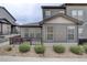 Charming townhome exterior with a private porch and landscaped with decorative rock and shrubbery at 11568 Dewey St, Parker, CO 80138