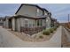 Attractive townhome exterior featuring private outdoor space with a porch and decorative landscaping at 11568 Dewey St, Parker, CO 80138