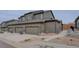 Exterior view of townhome features a spacious garage, a well-maintained yard, and a welcoming entrance at 11568 Dewey St, Parker, CO 80138
