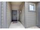 Inviting front entry with a decorated door, modern wall light, and welcoming doormat at 11568 Dewey St, Parker, CO 80138