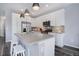 Bright kitchen with white cabinetry, stainless steel appliances, and kitchen island at 11568 Dewey St, Parker, CO 80138