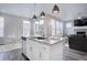 Bright kitchen with an island, modern pendant lighting, and a dining area with natural light at 11568 Dewey St, Parker, CO 80138