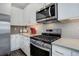 Contemporary kitchen with stainless steel appliances, tile backsplash, and ample counter space at 11568 Dewey St, Parker, CO 80138