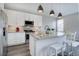 Modern kitchen with white cabinets, stainless steel appliances, and a functional center island at 11568 Dewey St, Parker, CO 80138