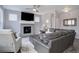 Inviting living room with a tiled fireplace, comfortable seating, and a ceiling fan at 11568 Dewey St, Parker, CO 80138
