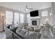 Bright living room featuring a tiled fireplace, plush sofa, and ample natural light at 11568 Dewey St, Parker, CO 80138