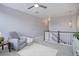 Loft featuring neutral walls and carpet, ceiling fan, and a comfy gray armchair at 11568 Dewey St, Parker, CO 80138