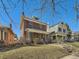 Charming brick home with a cozy front porch and well-maintained lawn in a historic neighborhood at 2411 N High St, Denver, CO 80205