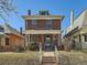 Inviting brick home with a charming front porch, showcasing its classic architecture and neighborhood charm at 2411 N High St, Denver, CO 80205