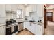 Bright kitchen with stainless steel appliances, granite counters and white subway tile backsplash at 2411 N High St, Denver, CO 80205