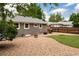 Backyard featuring a patio, grill, fire pit, artificial turf, and gravel landscaping at 8240 Grandview Ave, Arvada, CO 80002